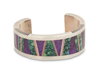 2041 A P. Platero Navajo sterling silver and mosaic inlay cuff bracelet P. Platero (b. 20th century, Diné) Late 20th/21st century Stamped: P Platero [script] / Sterling A heavy asymmetrical tapered cuff with multistone geometric mosaic inlay including variscite, sugilite and pink shell and with incised ridged edge detail 6.25" total inner C x 1" H, gap: 1.25" 90.3 grams gross Estimate: $200 - $400