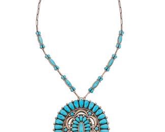 2069 A Lorraine Waatsa Zuni sterling silver and cluster set turquoise necklace Lorraine Waatsa (b. 20th century, Zuni Pueblo) Late 20th/21st century Stamped to plaque: LW Comprising an oval concho style sterling silver and cluster set turquoise pendant/brooch suspended from a paper clip chain with cluster set turquoise links 2 pieces 25" L x 4.125" H x 3.75" W 103.8 grams gross Estimate: $500 - $700
