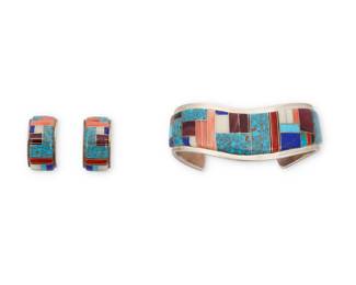 2272 A set of Southwest sterling silver and stone inlay jewelry Late 20th/21st century Stamped: Kristen / Sterling Two works comprising a chunky cuff bracelet with extensive raised stone channel inlay in turquoise, coral, sugilite, lapis lazuli, spiny oyster, and white shell, as well as a pair of matching half-circle earrings 3 pieces Cuff: 6.5" total inner C x 1" H, gap: 1.25"; Earrings: 1" H x 0.5" W 72.8 grams gross Estimate: $300 - $500