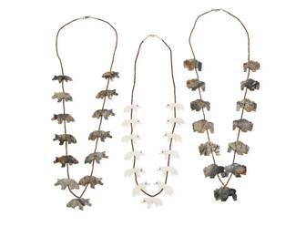 2275 A group of Sammy Smith Navajo carved stone fetish necklaces Sammy Smith (b. 20th century, Diné) Mid/late 20th century Unmarked, each with tag denoting artist Three works comprising two single strand necklaces, each with carved grey stone animals and fine brown heishi shell spacers, including one with bison, and one with wolves, as well as a shorter necklace with carved white marble coyotes 3 pieces 28" L & 25" L 185.2 grams gross Estimate: $300 - $500