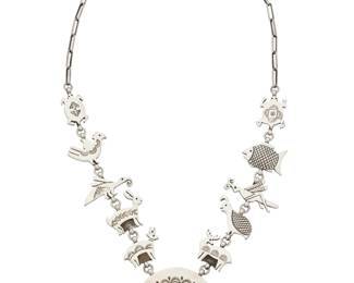 2147 A Herman Vandever Navajo sterling silver pictorial necklace Herman Vandever (b. 1964, Diné) Late 20th/21st century Etched signature verso A link necklace with various stylized animal links inspired by Mimbres motifs including turtle, fish, grasshopper, quail, deer, rabbit, birds, all suspending a lizard naja to the center 25" L x 2.125" H 114.5 grams Estimate: $800 - $1,200