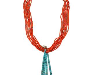 2168 A Pueblo multistrand coral necklace with jaclas Early/mid-20th century Unmarked An eight-strand dark red coral necklace with scattered silver pearls with a traditional wrapped neck cord, and suspending a pair of turquoise and shell jaclas 29" L x 6.75" H 167.6 grams gross Estimate: $700 - $900