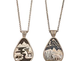 2237 Two Fritson Toledo Navajo sterling silver sculptural pendants Fritson Toledo, (b. 1961, Diné) Late 20th/21st century Each stamped: Toledo / Sterling Comprising two chunky figural teardrop pendants in sterling silver overlay, one featuring a wolf in a mountain landscape (23.5" L x 3.125" H) and the other featuring a bear and an elk at a riverbank (23" L x 3.125" H), each suspended from a sterling silver chain 4 pieces 141.8 grams Estimate: $300 - $500