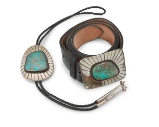 2239 A set of Southwest silver and turquoise jewelry Late 20th century Two works:  Michael R. Rogers (b. 20th century, Paiute) A Paiute sterling silver and turquoise belt buckle with belt Buckle stamped & etched: Michael Rogers; further stamped: Paiute / Handmade / [rabbit] / Sterling A chunky sterling silver buckle with shadowbox set slab turquoise and deeply incised accents, mounted to a black leather belt Buckle: 2.25" H x 3" W; Belt: 41.75" L x 1.375" H (size 35)  A Southwest sterling silver and turquoise bolo tie Unmarked [likely Michael R. Rogers, Paiute] A chunky sterling slide with shadowbox set slab turquoise and deeply incised accents, mounted to a braided black leather cord, with silver cone tips Bolo; 3.125" H x 2.25" W; cord: 37" L  2 pieces total 278.3 grams gross Estimate: $400 - $600