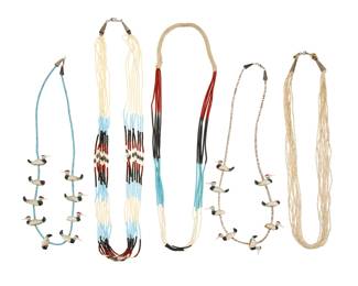 2215 A group of Pueblo turquoise and shell heishi jewelry Mid/late 20th century Unmarked Comprising two multistrand bead necklaces including turquoise, coral, heishi shell and fine white heishi, one with silver cone clasps and one with a traditional wrapped neck cord, as well as two shell and turquoise fetish necklaces with cowrie shell and glass duck fetish figures, and a multistrand multicolored glass bead necklace 5 pieces Longest: 32" L; shortest: 24" L 132.5 grams gross Estimate: $600 - $900