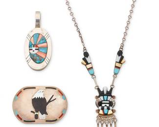 2199 A group of Zuni Pueblo silver and multistone inlay jewelry Late 20th/21st century Three pieces: Ric Laselute (b. 20th century, Zuni Pueblo) A Zuni sterling silver sculptural stone inlay pendant Stamped: Ric Laselute A large oval pendant with a Sunface motif in turquoise, pink stone and coral raised mosaic inlay 3.375" H x 1.5" W Andrew Dewa (d. 2001, Zuni Pueblo) A Zuni sterling silver and multistone inlay katsina pendant necklace Stamped A. Dewa / Sterling A silver link and stone inlay necklace featuring a stylized katsina figure pendant with silver dangles and two inlay links, all in turquoise, shell, and coral inlay and suspended from a paperclip chain 19" L x 2.375" H Sanford Edaakie (b. 1963, Zuni Pueblo) A silver and stone inlay bald eagle belt buckle Etched: S. C. Edaakie With carved stone and shell inlay bald eagle motif to center and turquoise, coral, and onyx ticked inlay to edges 2" H x 2.75" W 3 pieces 116.6 grams gross Estimate: $600 - $800