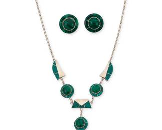 2192 A set of Julius Manuelito Navajo sterling silver and malachite jewelry Julius Manuelito (b. 20th century, Diné) Late 20th/21st century Necklace stamped to applied plaque: Julius Manuelito A delicate modernist-style chain link necklace with silver and set inlay malachite geometric shaped links suspending a drop link pendant, with a pair of similar design matching malachite earclips 3 pieces Necklace: 21" L x 2.875" H; Earrings: 1" Dia. 33.1 grams gross Estimate: $300 - $500