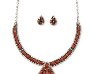 2267 A set of Southwest sterling silver and coral jewelry Late 20th century Each stamped for sterling; further variously stamped: Carlos [script] / RK [earrings] Comprising a sterling silver link necklace with row set coral links suspending a cluster set coral teardrop pendant, all suspended from a paperclip chain, and a pair of similar cluster set teardrop earrings 3 pieces Necklace: 23" L x 2.375" H; Earrings: 1" H 76.2 grams gross Estimate: $300 - $500