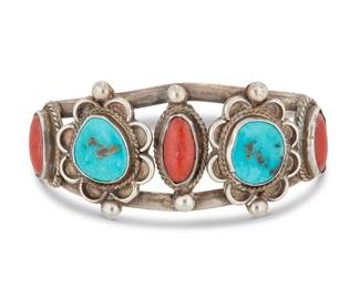 2011 A Southwest sterling silver, coral and turquoise cuff bracelet Mid-20th century Unmarked A two-wire openwork cuff with set turquoise and coral, each within an individual silver plaque 6.5" total inner C x 1.25" H, gap: 1.25" 47.0 grams gross Estimate: $300 - $500