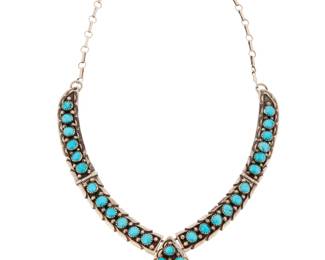 2093 A Larry Moses Yazzie Navajo sterling silver & turquoise necklace Larry Moses Yazzie (b. 20th century, Diné) Late 20th century Stamped: L.M.Y. / Sterling An articulated collar necklace with row set turquoise hinged links suspending a cluster set teardrop pendant, with chain links and claw clasp 17.5" L x 1.375" H 47.3 grams gross Estimate: $300 - $500