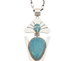 2113 An Esther Wood Navajo sterling silver and turquoise pendant Esther Wood (b. 1946, Diné) Late 20th century Comprising a large sterling silver figural katsina pendant with set turquoise cabochons and incised silver accents, possibly China Mountain turquoise, suspended by a detachable bail from a long sterling silver paper clip chain 30.5" L x 5.375" H x 2.375" W 124.3 grams gross Estimate: $700 - $900