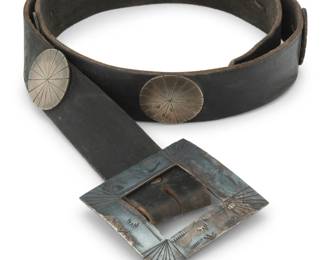 2106 A Southwest style concho belt Mid-20th century Unmarked A leather belt with a sterling silver rectangular buckle with incised and stampwork accents, eight round nickel silver concho discs, each with deeply incised line details, and all mounted to a leather belt strap Buckle: 2.625" H x 2.5" W; each concho: 1.375" Dia.; Belt: 40" L x 1.25" H (Size 40) 220.2 grams gross Estimate: $300 - $500