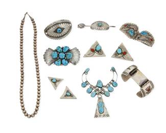 2287 A large group of Southwest silver jewelry Mid/late 20th century Variously marked for maker or sterling: S.K Emerson [Diné] / B. Nez [Diné] / JR [for Jerry Roan, Diné] / B.S. [in mosaic inlay] Nine works comprising a Jerry Roan Navajo elaborate set turquoise pendant with stamped silver central dangle (4.75" H x 3.25" W), an SK Emerson Navajo stamped silver and cluster set concho style pendant/brooch (2" H x3.5" W), as well as a pair of B. Nez Navajo sterling silver and set turquoise and coral watch band ends with silver feather and wire overlay( each 1.5" H x 2" W), a B.S. heavy watch cuff with mosaic stone inlay peyote bird motifs (7" inner C x 1.5" H), and two stamped silver and set turquoise concho style hair slides (2" H & 1.125" H), together with two pairs of silver and set stone shirt collar ends (2" x 1.75" & 11.25" x 1.25"), and a single strand of silver beads (22" L) 11 pieces 312.2 grams gross Estimate: $300 - $500