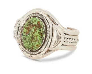 2160 A Wilbert Vandever Navajo sterling silver and set stone cuff bracelet Wilbert [William] Vandever (1951-2018, Diné) Late 20th/21st century Stamped: WCV [within a feather] A heavy five wire cuff with large central oval set green variscite stone and twisted wire and stamped accents 6.25" total inner C x 1.875" H, gap: 1" 95.6 grams gross Estimate: $400 - $600
