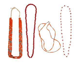 2211 A group of Pueblo trade bead necklaces Early/mid-20th century Unmarked Four necklaces comprising three strands of orange trade beads with silver bead spacers (31" L), a short double strand of orange trade beads and heishi shell spacers (20.25" L), a single strand of red glass 'white heart' beads (34" L), and a single strand of dentalium shells with red glass 'white heart' bead spacers (32" L) 4 pieces 182.1 grams gross Estimate: $300 - $500