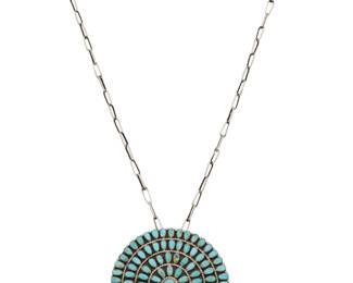 2092 A Larry Moses Begay Navajo sterling silver and cluster set turquoise necklace Larry Moses Begay (b. 20th century, Diné) Late 20th century Stamped: LMB / Sterling A round pendant/brooch with concentric rows of petit point turquoise, suspended from a handmade paperclip chain 24.5" L x 3" Dia. 56.6 grams gross Estimate: $300 - $500