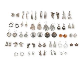 2306 A group of Southwest style silver earrings Mid/late 20th century Many variously marked for sterling; some for maker: Melesio Rodriguez, Mex / MO, Mex Thirty pairs of silver or mixed metal earrings in various styles and sizes including modernist, pictorial, conchos, storytellers, fish, Mayan figures, grapes, peacocks, hearts, overlay rings, silver hoops of various sizes, silver beads, and eight pairs of Mexican silver earrings 60 pieces Largest: 2.5" H; Smallest: 0.5" H 214.9 grams gross Estimate: $200 - $400