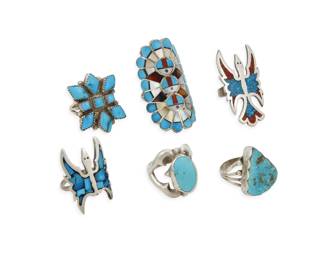 2259 A group of Zuni Pueblo style silver rings Mid/late 20th century Unmarked Six turquoise rings in various styles and sizes including a Zuni style multistone inlay Sunface ring, a cluster set ring, two chipped mosaic inlay 'Peyote Bird' rings, and two single set turquoise rings 6 pieces Ring sizes: 10 to 7 62.2 grams gross Estimate: $300 - $500