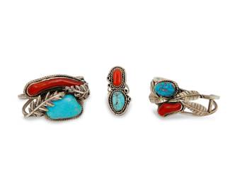 2219 A group of Southwest sterling silver, turquoise and coral jewelry Mid/late 20th century Each unmarked Comprising two chunky two wire cuffs, each with set turquoise and coral and with applied silver feather and leaf accents, together with a set turquoise and coral ring Larger cuff: 6.25" total inner C x 1.375" H, gap: 1.25"; Smaller: 6" total inner C x 1.75" H, gap: 0.875"; Ring size: 8; 1.875" H 109.1 grams gross Estimate: $500 - $700