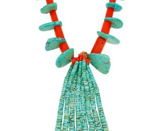 2165 A large Pueblo coral and turquoise necklace Mid-20th century Unmarked A chunky single strand necklace with large Mediterranean coral graduated beads alternating with graduated turquoise tabs, suspending four turquoise jaclas 26.5" L x 5.25" H 393.1 grams gross Estimate: $800 - $1,200