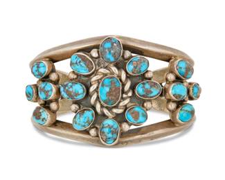 2022 A Franklin Thompson Navajo sterling silver and turquoise cuff bracelet Franklin Thompson (b. 20th century, Diné) Late 20th century Stamped: F. Thompson A heavy three wire cuff with cluster set turquoise with heavy matrix and rope wire accents 6.5" total inner C x 1.75" H, gap: 1.25" 91.9 grams gross Estimate: $400 - $600