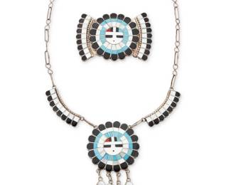 2072 A set of J.D. Massie Zuni Sunface sterling silver and multistone inlay jewelry Jose Massie or Dora Massie (both b. 1943, Zuni Pueblo) Late 20th century Each stamped to plaque: J.D. Massie [for Jose or Dora Massie, Zuni] Comprising a multistone inlay pictorial link necklace with a central Sunface plaque of mother of pearl, turquoise, coral, and black stone, with stone inlay dangles, suspended from two narrow inlay links and chunky handmade paperclip chains, with a matching Sunface belt buckle 2 pieces Necklace: 19.5" L x 3.75" H; Buckle: 1.875" H x 2.875" W, belt bar: 1.25" 79.9 grams gross Estimate: $400 - $600