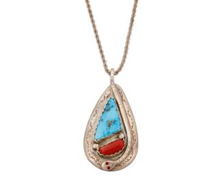 2079 An Effie Calavaza Zuni sterling silver and set stone pendant Effie Calavaza (1927-2019, Zuni Pueblo) Mid/late 20th century Stamped: Effie C. / Sterling A large sterling silver teardrop pendant with set turquoise and coral, and featuring a fine silver overlay snake motif to one side, with an associated later silver chain 2 pieces 18" L x 2.25" H x 1.25" W 32.7 grams gross Estimate: $200 - $300