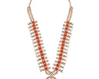 2117 A Navajo 'Box & Bow' sterling silver and coral squash blossom necklace Attributed to Alice Blackgoat (b. 20th century, Diné) Mid/late 20th century Unmarked With a central set stone sterling silver three wire naja and thirty diminutive box and bow stamped sterling silver blossoms, all set to a double-strand of silver beads 25" L x 2" H 136.9 grams gross Estimate: $1,500 - $2,000