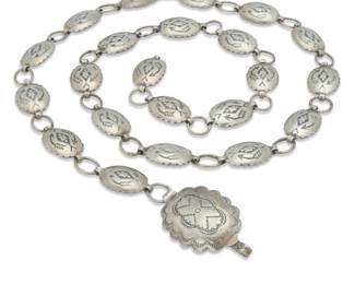 2108 A Southwest sterling silver link concho belt Mid/late 20th century Stamped: Sterling A diminutive silver link belt with stamped oval conchos and a larger stamped buckle with hook 32.375" L x 1.125" H (buckle); each concho: 0.625" H x 1" W 74.1 grams Estimate: $400 - $600