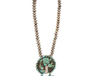 2056 A Federico Jimenez large sterling silver and turquoise pendant necklace Federico Jimenez (b. 1941, Mixtec) Late 20th/21st century Stamped: JF [conjoined] / Sterling A large chunky two-piece articulated pendant, one section a disc, and one a heart shape, each with set slab turquoise and edged with row set turquoise, each with a central band of heart-stamped silver, and all suspended from a chunky strand of stamped silver coin-style beads 27" L x 6" H x 3.375" W 326.2 grams gross Estimate: $2,000 - $3,000