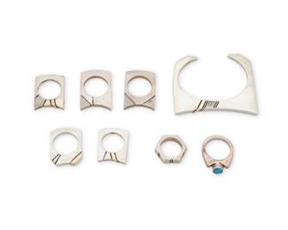 2034 A group of sterling silver and 14K gold jewelry Nusie Henry [Belon] (b. 20th century, Diné) Late 20th century Most stamped: Sterling / 14K; tags denote Nusie Henry and G. King as artists Comprising a modernist style sterling silver cuff bracelet and seven sterling silver stackable modernist rings in various styles and shapes, some with 14K gold overlay accents, one with set turquoise 8 pieces Cuff: 5.75" total inner C x 0.75" H, gap: 0.875"; Ring sizes: 8 to 5 135.9 grams gross Estimate: $400 - $600