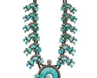 2059 A Federico Jimenez turquoise Rainbow Guardian squash blossom necklace Federico Jimenez (b. 1941, Mixtec) Late 20th/21st century Stamped: JF [conjoined] / Sterling A double strand necklace with twelve sterling silver mosaic inlay Rainbow Guardian 'blossoms' suspending a large Rainbow Guardian 'naja', each with turquoise inlay 27.25 to 29" L x 3.625" H 337.8 grams gross Estimate: $1,000 - $1,500