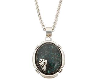 2149 A Herman Vandever Navajo Lander turquoise and silver necklace Herman Vandever (b. 1964, Diné) Late 20th/21st century Etched signature verso A large oval sterling silver pendant with set turquoise, likely Lander turquoise, with an applied silver Kokopelli figure to the cabochon, all suspended with a detachable bail from an associated sterling silver chain 20" L x 2.375" H x 1.5" W 48.0 grams gross Estimate: $600 - $800