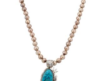 2114 An Esther Wood Navajo sterling silver and turquoise pendant Esther Wood (b. 1946, Diné) Late 20th century Etched signature verso A large pendant with an oval set slab turquoise stone edged with incised silver with a silver overlay katsina figure to one side, suspended from a single strand of graduated silver beads 28" L x 3.75" H x 1.75" W 187.6 grams gross Estimate: $400 - $600