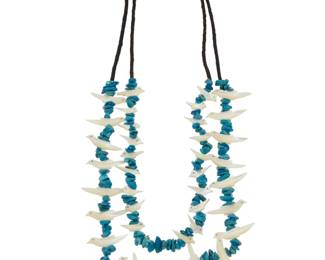 2180 A Pueblo style carved fetish necklace Late 20th century Unmarked Comprising a two-strand necklace of turquoise nuggets alternating with carved mother of pearl birds 29.5" L 130.4 grams gross Estimate: $200 - $400