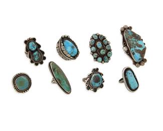 2200 A group of large Southwest silver and turquoise rings Mid/late 20th century Two variously stamped: [feather pictograph] / YTH with in a circle Eight turquoise rings in various styles and sizes including bezel set and cluster set, some with applied wire edging, and one with applied silver feather accent 8 pieces Ring sizes: 8.75 to 5.5 125.6 grams gross Estimate: $600 - $800