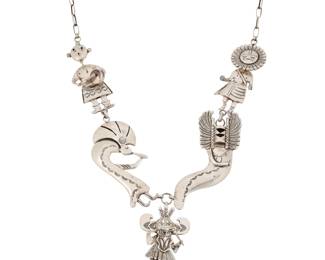 2110 An Esther Wood Navajo sterling silver katsina necklace Esther Wood (b. 1946, Diné) Late 20th/21st century Etched signature verso A chunky link necklace with various articulated and stamped sterling silver figural links featuring different katsina dancers including Sunface, Kokopelli, and Mudhead, all suspending a central articulated pendant/brooch of a katsina figure with tiered feather skirts 27" L x 3.5" H 174.7 grams gross Estimate: $800 - $1,200
