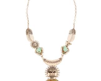2138 A Bennie Ration Navajo sterling silver and turquoise necklace Bennie Ration (b. 1955, Diné) Late 20th/21st century Stamped: BR / [bird of prey talon] / Sterling Comprising an elaborate link necklace featuring three figural brooch/pendants including a central katsina figure as well as a Sunface and a Mudhead figure, each set with pale green turquoise and each suspended as a detachable link from the silver necklace with feathers and stamped motifs 22" L x 3.5" H 117.4 grams gross Estimate: $800 - $1,200
