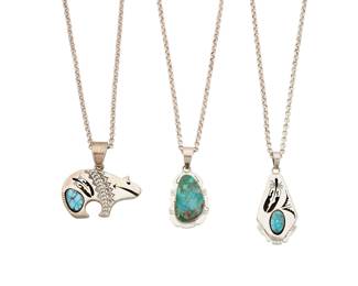 2144 A group of Bennie Ration Navajo sterling silver and turquoise pendants Bennie Ration (b. 1955, Diné) Late 20th/21st century Each stamped: B.R. / Sterling / [talon picto] Three works comprising a heartline bear pendant and a trapezoid pendant, each in sterling silver shadowbox overlay featuring set turquoise and openwork feather motifs, as well as a set turquoise pendant with incised silver edge detail, each suspemded from a sterling silver chain 6 pieces Pendants: 2.5" H to 2" H; chains: 22" L to 20" L 129.9 grams gross Estimate: $600 - $800