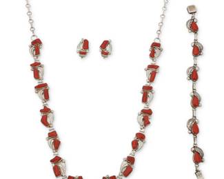 2208 A group of Southwest sterling silver and coral jewelry Late 20th century Three works:  Claudine Penketewa (b. 20th century, Zuni Pueblo) A set of Zuni sterling silver and coral jewelry Stamped: CP / © / Sterling; etched: Zuni [likely Claudine Penketewa, Zuni] Comprising a delicate silver link necklace, each link with set carved coral and applied silver feather accents, suspended from paper clip chains, and with a pair of matching earclips 3 pieces Necklace: 28" L x 0.625" H; Earrings: 0.75" H approximately  Carmelita Simplicio, (b. 20th century, Zuni Pueblo) A Zuni sterling silver and set coral link bracelet Stamped: Simplicio / Sterling A delicate bracelet, each link with set coral and applied silver feather accents 7.5" L x 0.5" H  4 pieces total 64.4 grams gross Estimate: $400 - $600
