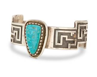 2024 An Alvin Tso Navajo cast sterling silver and turquoise cuff bracelet Alvin Tso (b. 20th century, Diné) Late 20th/21st century Stamped to interior: Alvin Tso / Sterling / [mountain and cloud pictographs] A heavy sand-cast silver geometric overlay cuff with central tapered turquoise stone set in a raised bezel mount 6.5" total inner C x 1.25" H, gap:1.25" 66.5 grams gross Estimate: $200 - $400