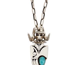 2142 A Bennie Ration Navajo sterling silver and turquoise katsina pendant necklace Bennie Ration (b. 1955, Diné) Late 20th/21st century Stamped: B.R. / Sterling / [talon picto] A large ram's head kachina figure pendant/ brooch with a shadowbox inset turquoise stone and silver overlay geometric accents, suspended from a handmade paperclip chain 2 pieces 24" L x 2.75" H x 1.5" W 76.9 grams gross Estimate: $300 - $500