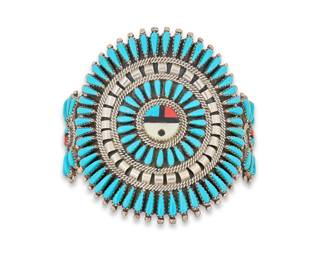 2082 A Nathaniel & Rosemary Nez Navajo needlepoint turquoise cuff bracelet Nathaniel and Rosemary Nez (B. 20th century, Diné) Late 20th century Etched: N & R Nez A large sterling silver three wire plaque with cluster set needlepoint turquoise, sterling banding and central multistone inlay including turquoise, mother of pearl and coral, with smaller plaques to shoulders 6.5 total inner C x 1.875" H, gap: 1.5" 59.5 grams gross Estimate: $400 - $600