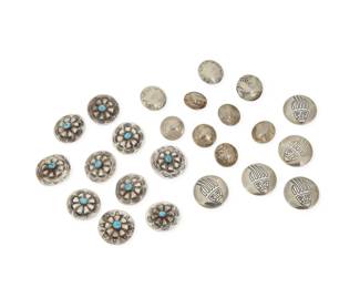 2312 A group of Southwest style silver buttons and button covers Mid/late 20th century Unmarked Comprising multiple silver buttons in various sizes and styles, including a mixed set of ten sterling silver stamped concho style buttons with central set turquoise (1.25" Dia. & 1.125" Dia.), a set of three stamped silver metal buttons (1" Dia.), six Buffalo/Indian Head nickel coin buttons (0.75" Dia.), and a set of five sterling silver stamped button covers with a bear claw motif 24 pieces 94.2 grams gross Estimate: $100 - $200