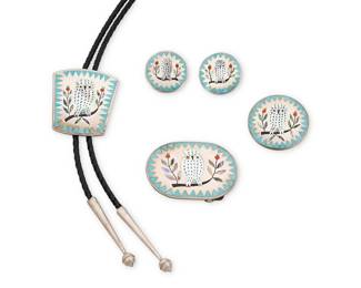 2066 A set of Dennis & Nancy Edaakie Zuni multistone inlay Snowy Owl jewelry Dennis and Nancy Edaakie (1931-2008 and b. 20th century, Zuni Pueblo) Late 20th century Each stamped: Dennis and Nancy Edaakie Four works featuring white owls in sterling silver and stone inlay including turquoise, mother of pearl, shell, and coral, comprising a bolo tie with black leather cord and silver tips, a pendant/brooch, a belt buckle, and a pair of round earrings 5 pieces Bolo slide: 2" H x 1.75" W; cord: 38" L; Brooch: 1.625" Dia.; Buckle: 1.75" H x 2.375" W; Earrings: 1.125" Dia. 101.9 grams gross Estimate: $800 - $1,200