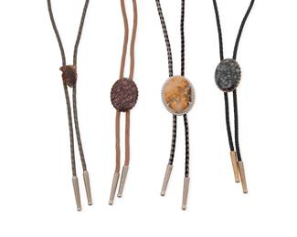 2251 A group of Southwest style stone set bolos Late 20th century Unmarked Comprising four mixed metal bolo ties, three with various oval polished stone slides in tones of grey, brown, and red, and one slide with an arrowhead-shaped stone, each mounted to a braided cord of various colors, and each with metal tips 4 pieces Largest bolo slide: 2" H x 1.5" W; Smallest: 1.25" H x 0.75" W; cords: 36" L to 34" L approximately 119.0 grams gross Estimate: $100 - $200
