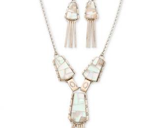 2226 A set of John Charley Navajo sterling silver and mother of pearl inlay jewelry John Charley (b. 20th century, Diné) Late 20th/21st century Stamped: J. Charley [script] / Sterling Comprising a sterling silver link necklace with elaborate mother of pearl mosaic inlay links suspending a central pendant with multiple silver dangles, with a pair of matching earrings with silver dangles 3 pieces Necklace: 17.5" L x 3.5" H; Earrings: 3" H 62.8 grams gross Estimate: $400 - $600
