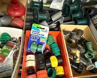 Assorted Garden Hose Fittings, Sprinklers, and Fertilizers