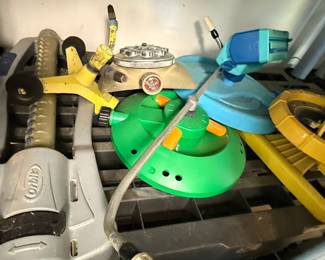 Assorted Garden Hose Fittings, Sprinklers, and Fertilizers