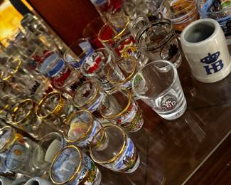 Collectible shot glasses from a variety of locations, including Europe